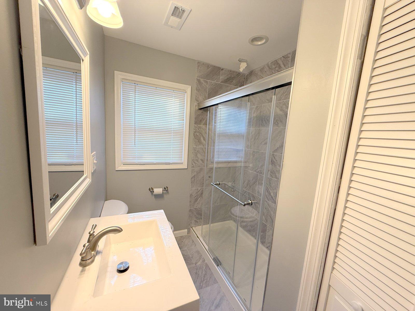 12 Wesley Avenue Cherry Hill, NJ 08002 - Photo 11 of 24 a bathroom with a tub a sink and a mirror