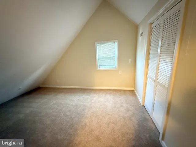 a view of an empty room and a window