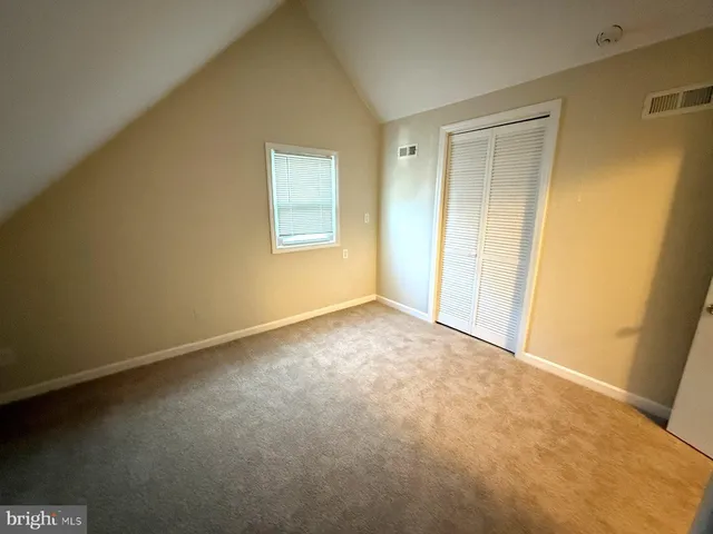 a view of an empty room and a window