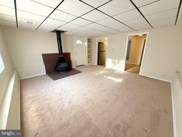 a large bed sitting in a spacious bedroom next to a window