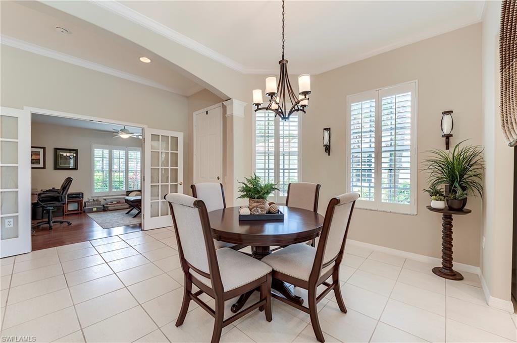 9296 Spring Run Boulevard Estero, FL 34135 - Photo 11 of 38 a view of a dining room with furniture window and wooden floor