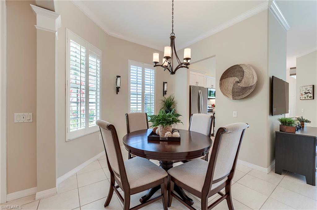 9296 Spring Run Boulevard Estero, FL 34135 - Photo 12 of 38 a view of a dining room with furniture window and wooden floor