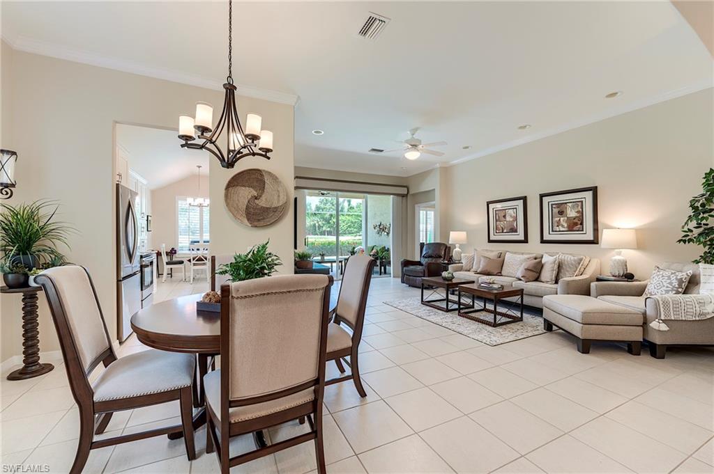 9296 Spring Run Boulevard Estero, FL 34135 - Photo 13 of 38 a dining room with furniture a chandelier and window
