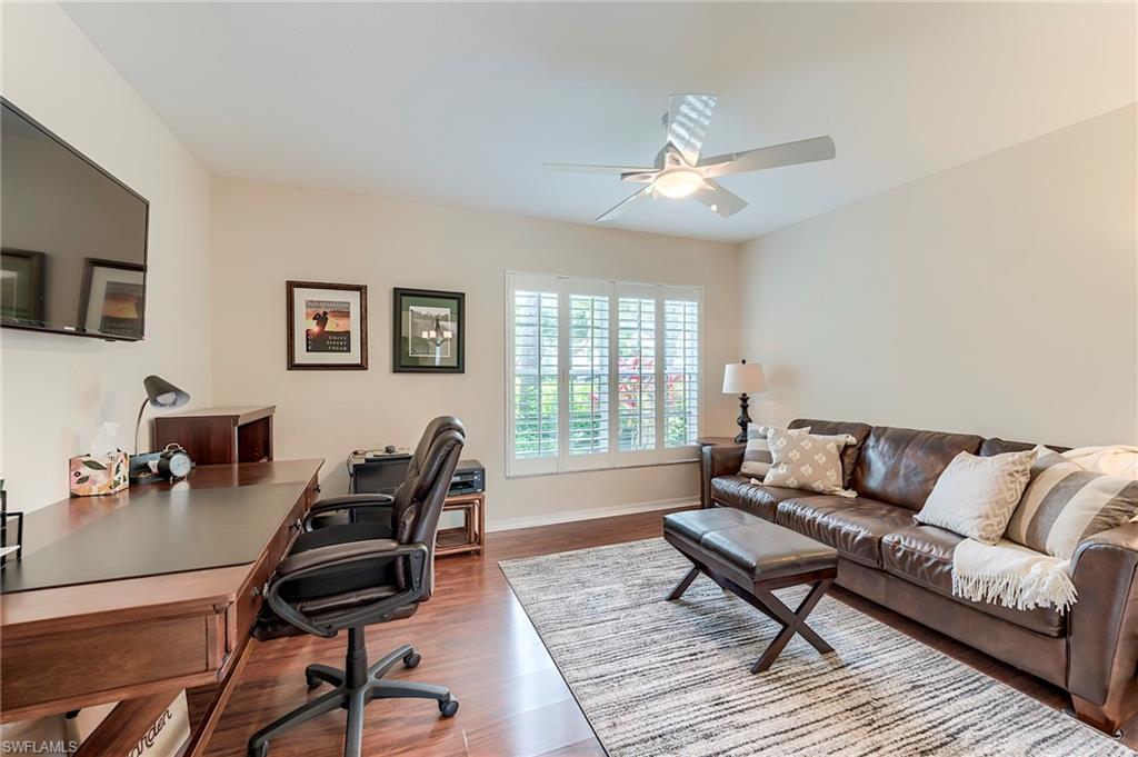 9296 Spring Run Boulevard Estero, FL 34135 - Photo 18 of 38 a living room with furniture and a wooden floor