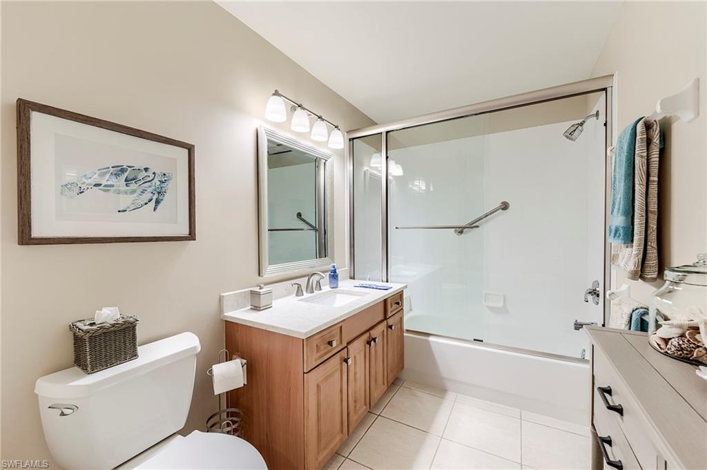 9296 Spring Run Boulevard Estero, FL 34135 - Photo 19 of 38 a bathroom with a double vanity sink toilet mirror and bathtub