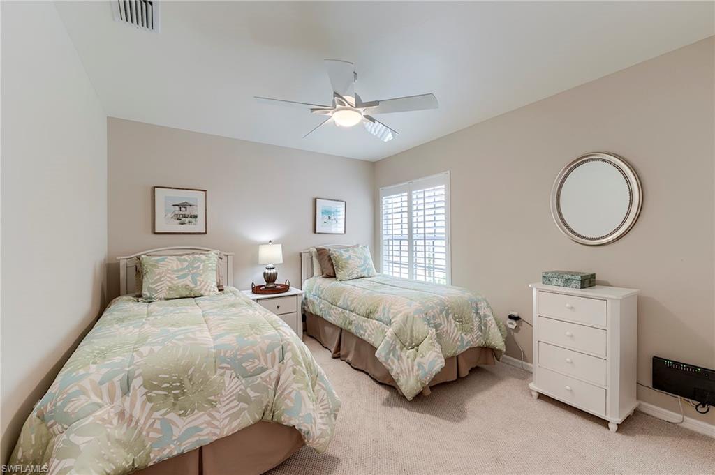 9296 Spring Run Boulevard Estero, FL 34135 - Photo 20 of 38 a bedroom with two beds and a window