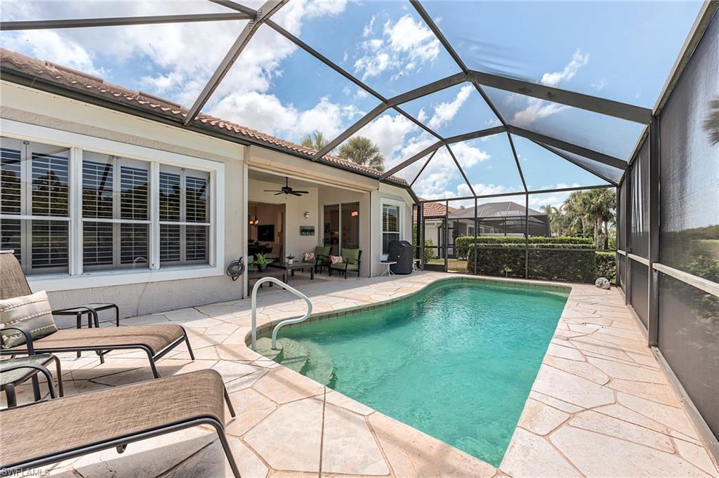 9296 Spring Run Boulevard Estero, FL 34135 - Photo 24 of 38 a view of a patio with a table and chairs