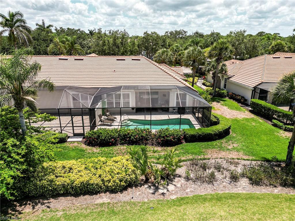 9296 Spring Run Boulevard Estero, FL 34135 - Photo 28 of 38 a aerial view of a house next to a yard