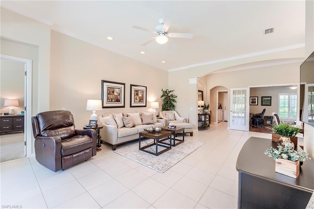 9296 Spring Run Boulevard Estero, FL 34135 - Photo 5 of 38 a living room with furniture and view of kitchen