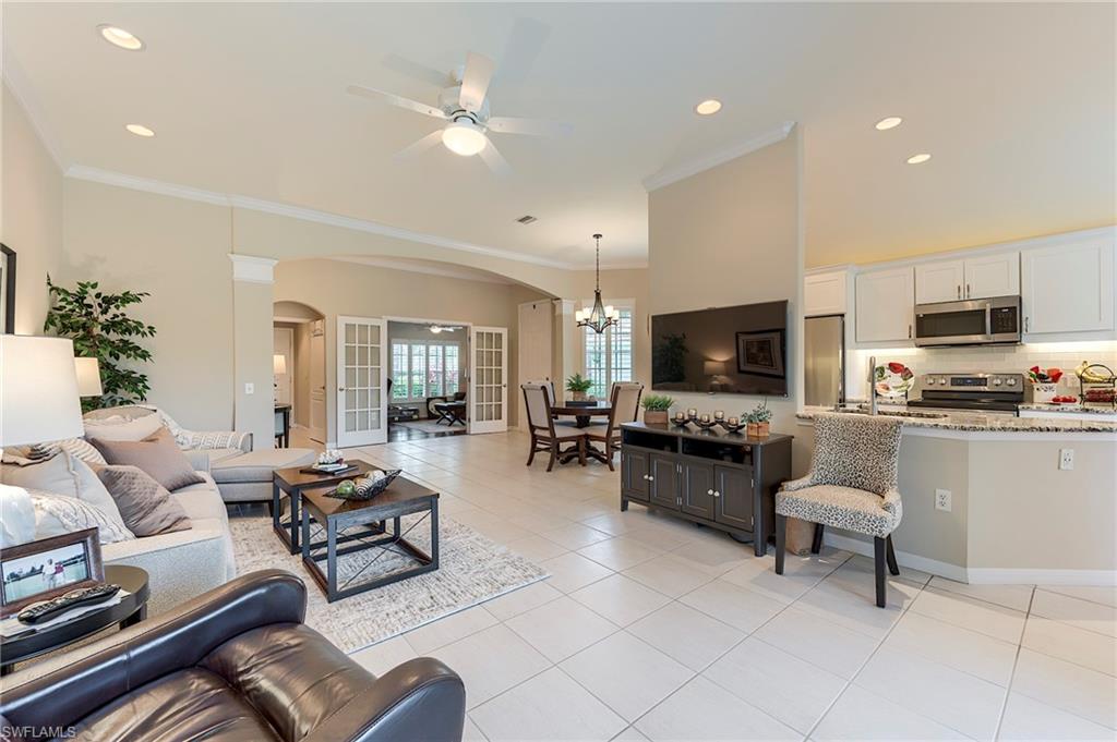 9296 Spring Run Boulevard Estero, FL 34135 - Photo 6 of 38 a living room with furniture and a flat screen tv