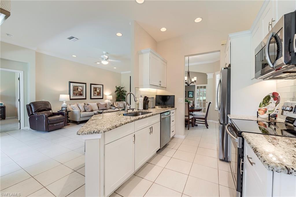 9296 Spring Run Boulevard Estero, FL 34135 - Photo 7 of 38 a large kitchen with stainless steel appliances lots of counter top space