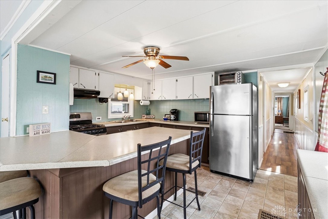 246 North Orchard Island Road Russells Point, OH 43348 - Photo 13 of 43 This spacious kitchen offers a large breakfast bar, ample counter space, and modern appliances.
