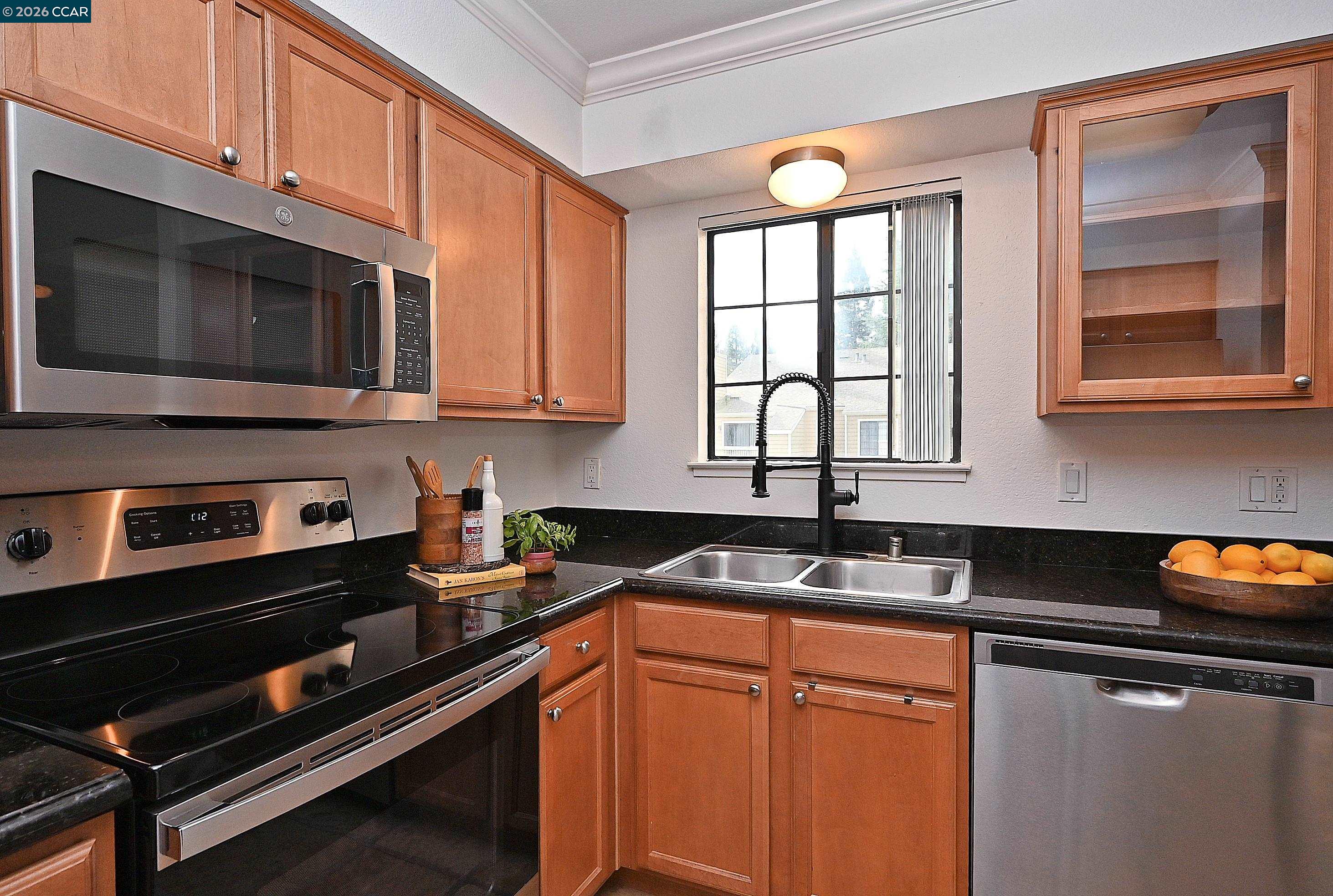 182 Eastridge Drive San Ramon, CA 94582 - Photo 13 of 47 a kitchen with stainless steel appliances granite countertop a stove a microwave and a sink