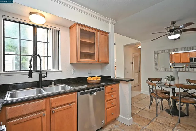 a kitchen with stainless steel appliances granite countertop a sink stove and cabinets