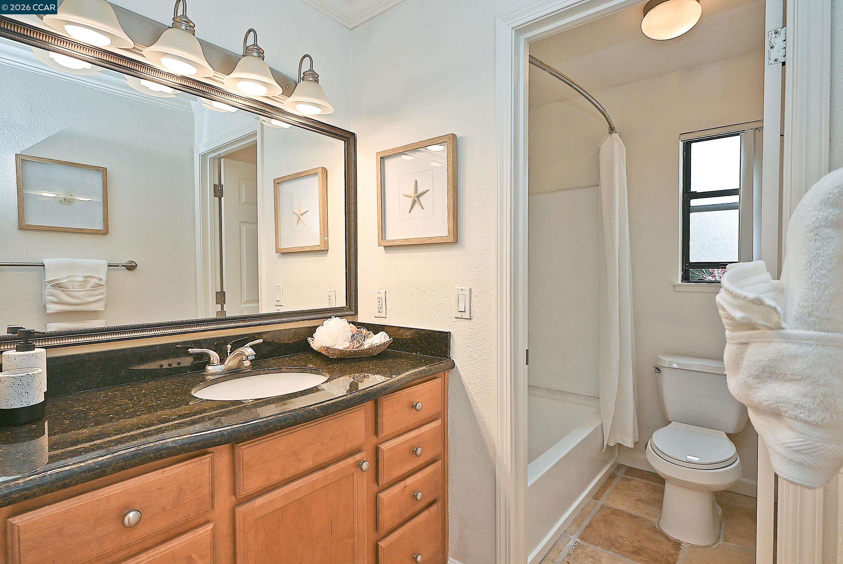 182 Eastridge Drive San Ramon, CA 94582 - Photo 24 of 47 a bathroom with a granite countertop sink toilet and shower