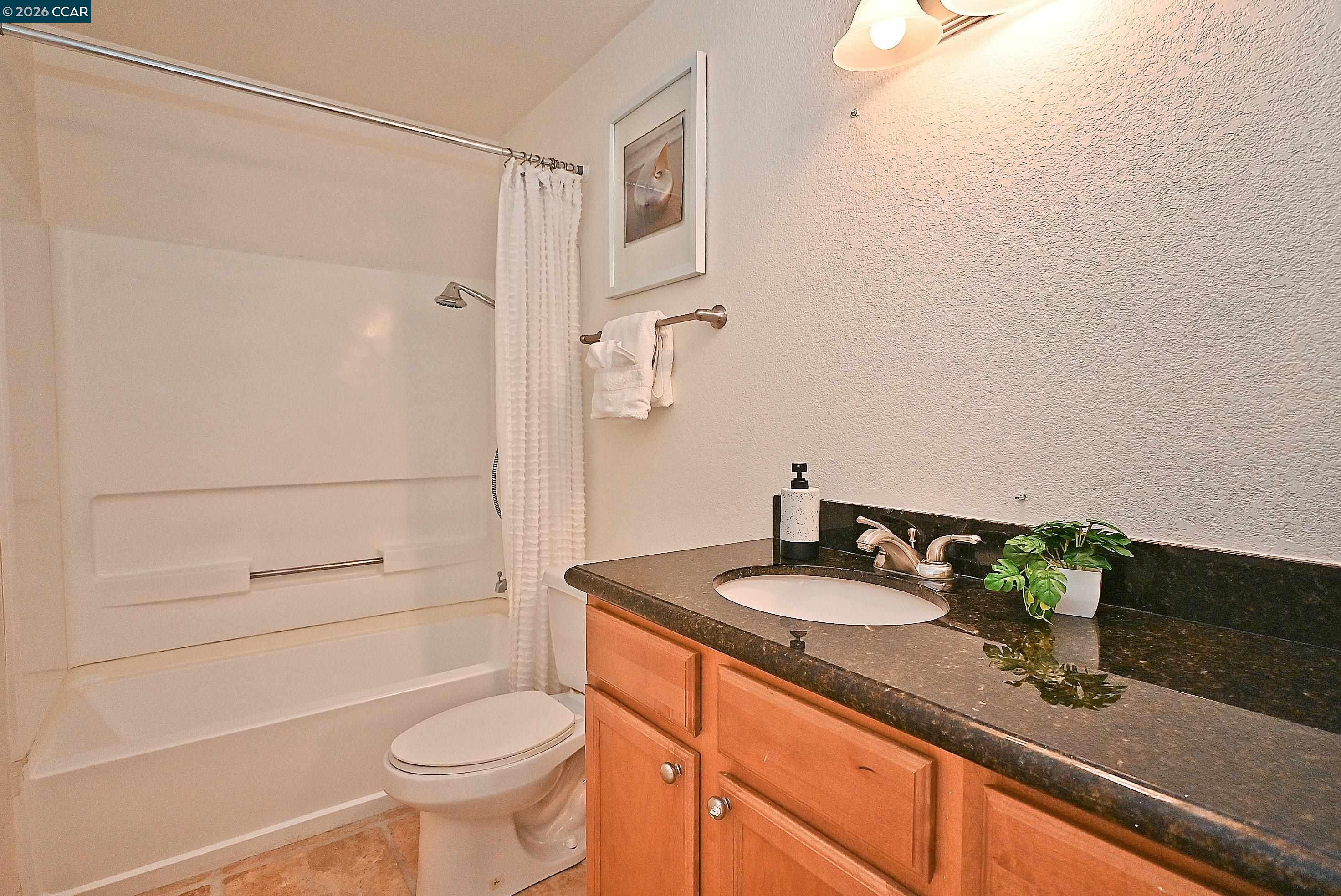 182 Eastridge Drive San Ramon, CA 94582 - Photo 26 of 47 a bathroom with a granite countertop sink toilet and shower