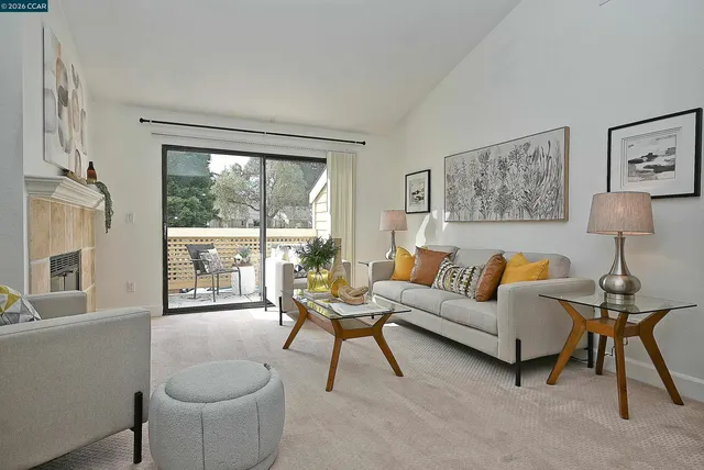a living room with furniture and a floor to ceiling window