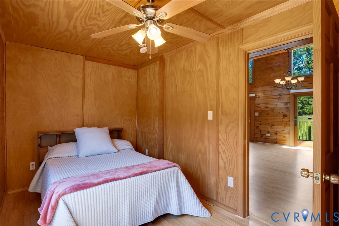 3000 Mineral Springs Road Boydton, VA 23917 - Photo 20 of 42 a bedroom with a bed and a chandelier