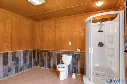 a view of balcony with wooden floor and fence and a yard