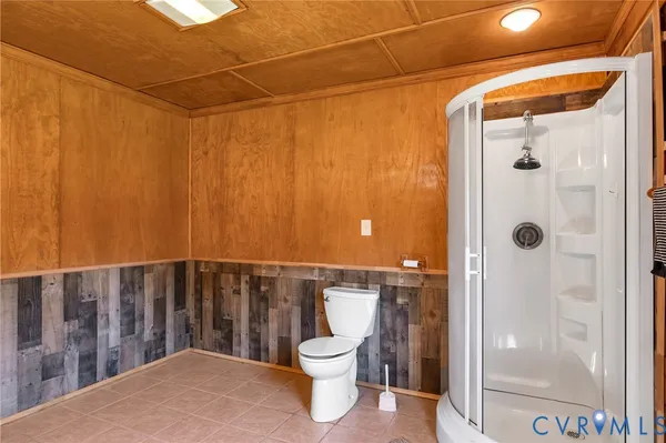 a view of balcony with wooden floor and fence and a yard