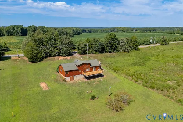 an aerial view of a houses with a lake view