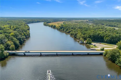 a view of a lake with lawn chairs