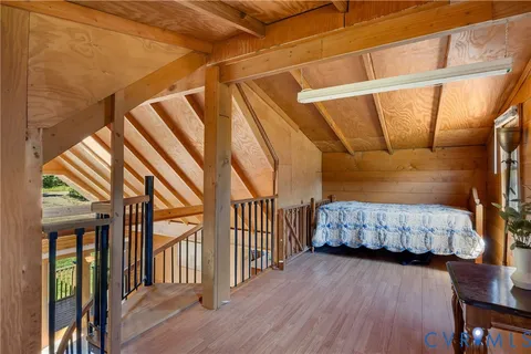 a kitchen with stainless steel appliances kitchen island granite countertop a table chairs in it and a wooden floors