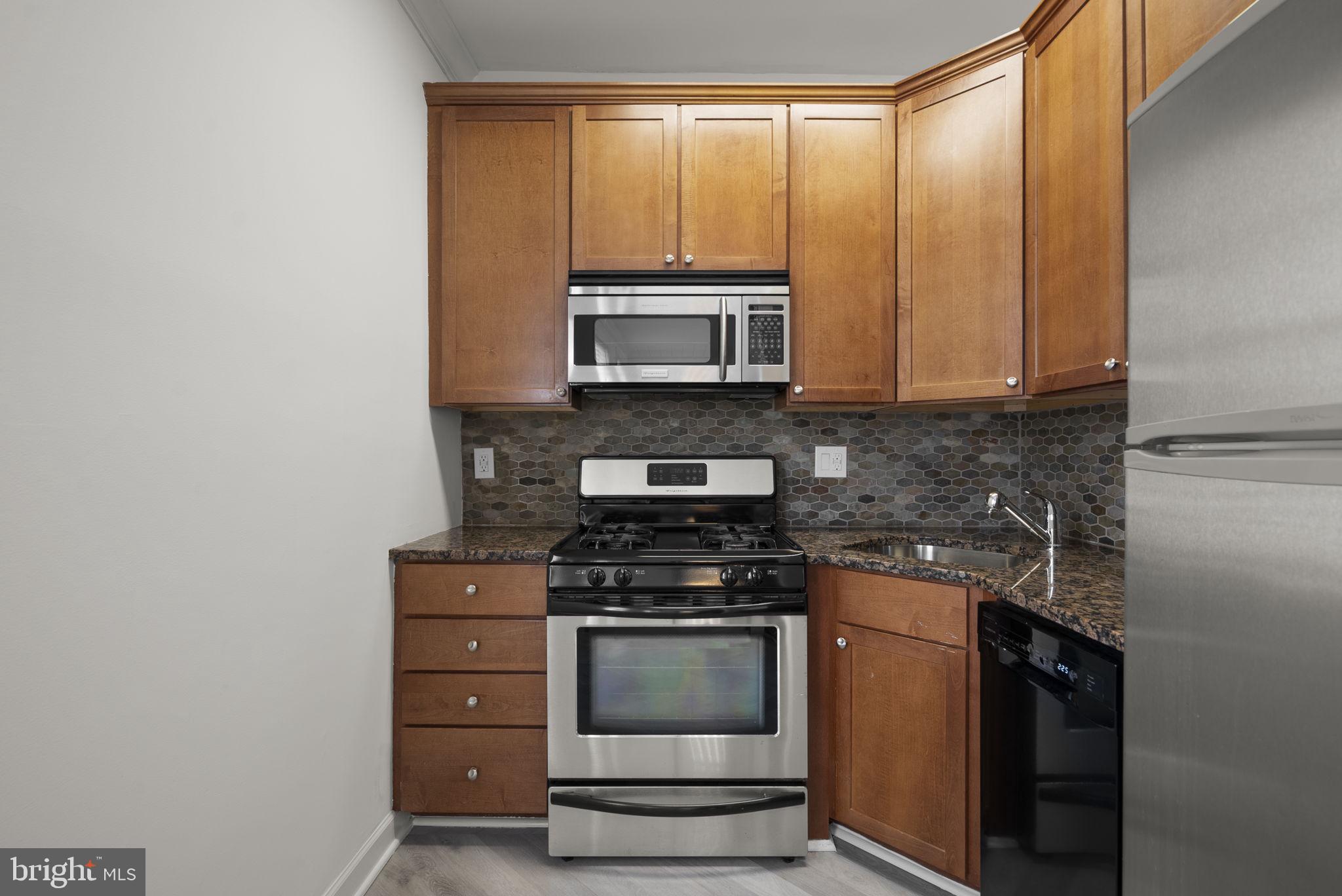 1816 Kalorama Road Northwest, Unit 304 Washington, DC 20009 - Photo 12 of 24 Cherry cabinets, granite counters