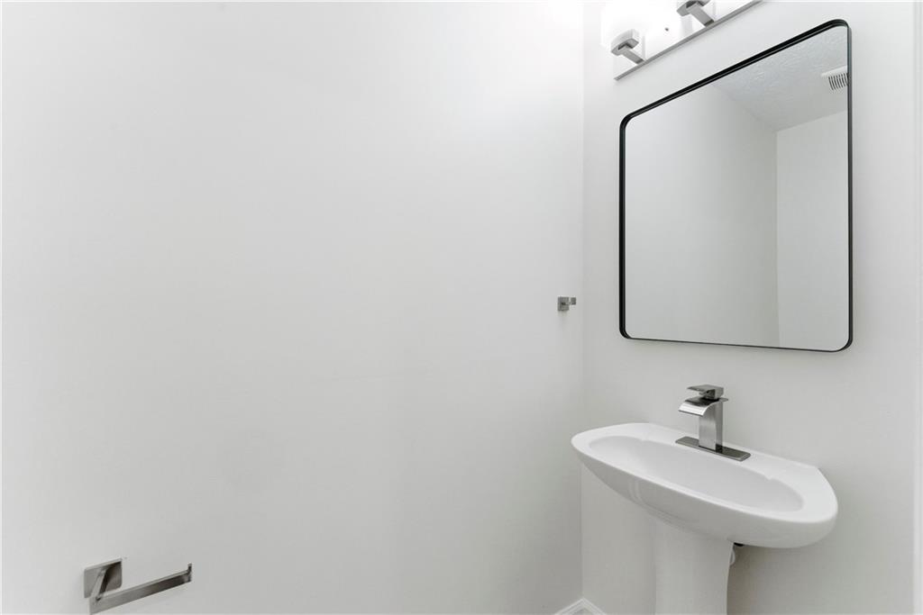 1500 Keystone Drive Conley, GA 30288 - Photo 14 of 25 a bathroom with a sink and mirror