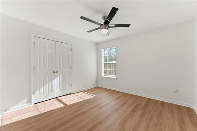 wooden floor in an empty room with a window