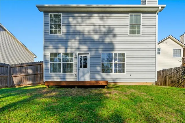 a front view of a house with a yard table and chairs