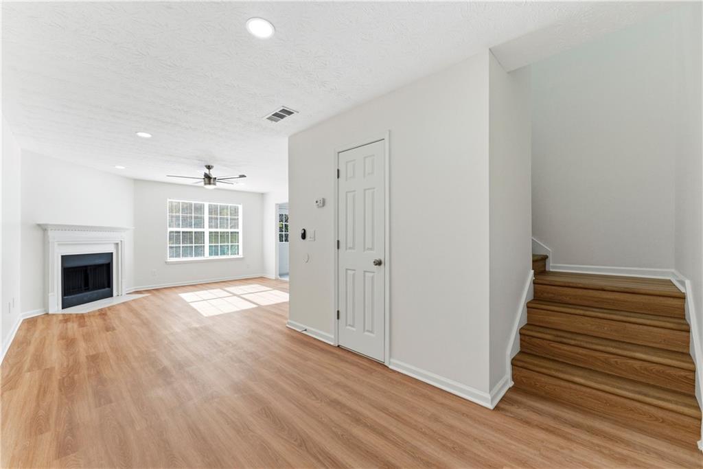 1500 Keystone Drive Conley, GA 30288 - Photo 4 of 25 a view of a livingroom with wooden floor and a fireplace