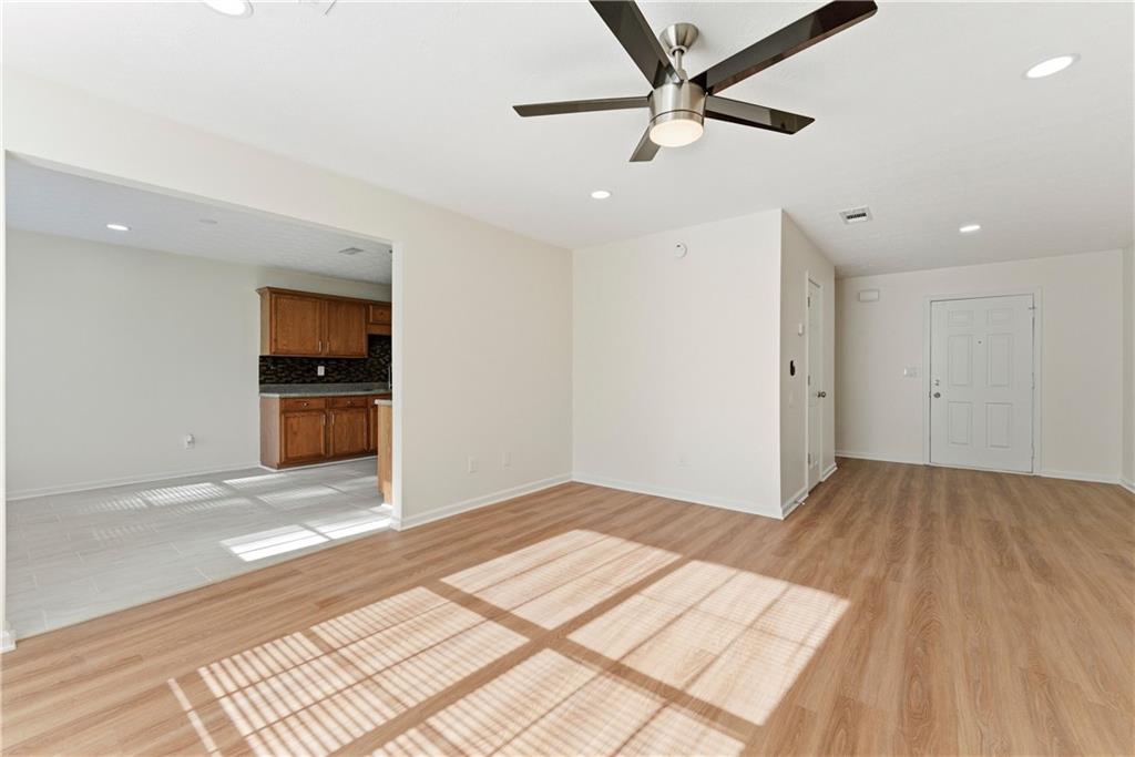 1500 Keystone Drive Conley, GA 30288 - Photo 5 of 25 a view of empty room with wooden floor and kitchen view