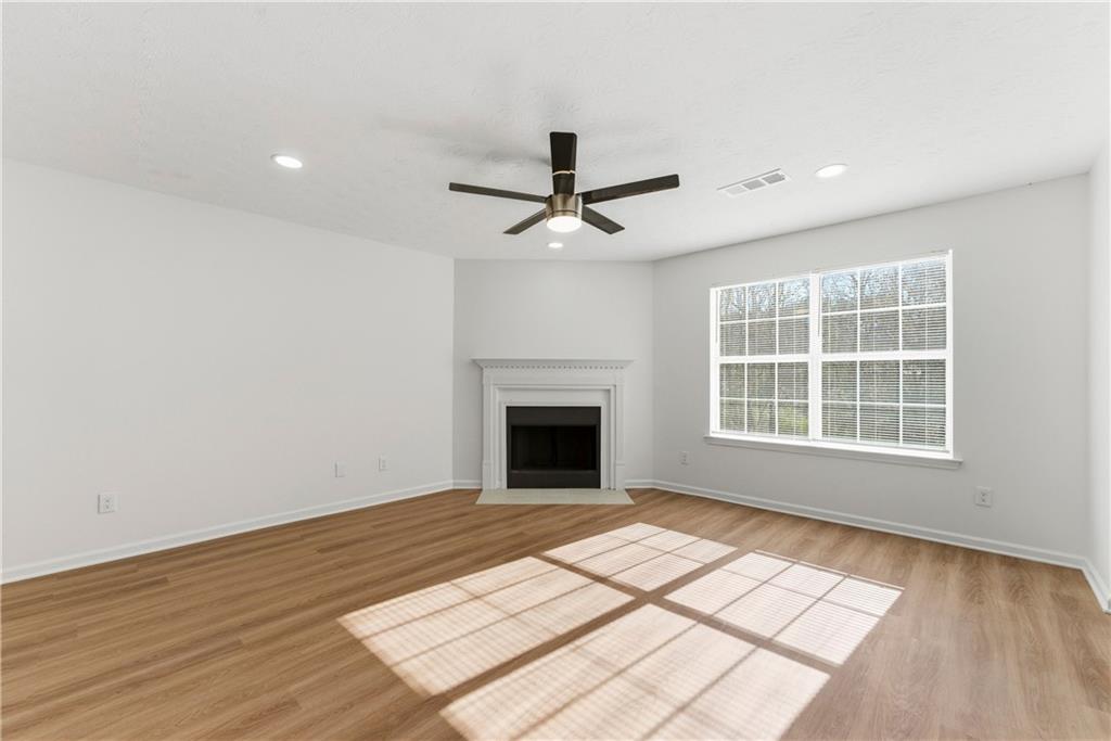 1500 Keystone Drive Conley, GA 30288 - Photo 6 of 25 a view of an empty room with wooden floor and a window