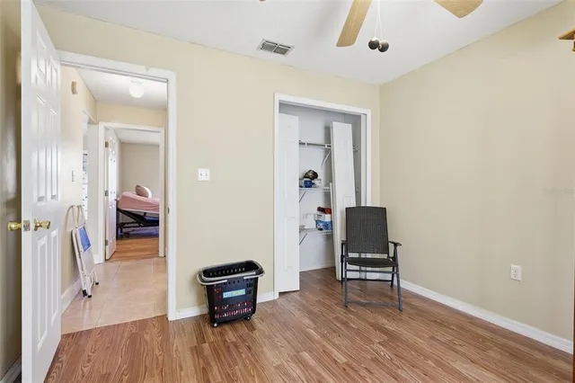 a view of a room with wooden floor and furniture