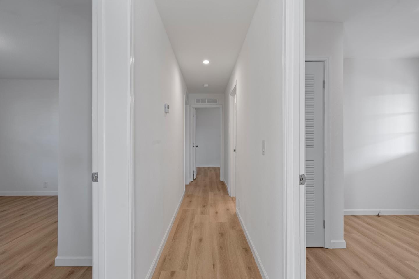 144 Holm Road, Unit 120 Watsonville, CA 95076 - Photo 16 of 25 a view of a hallway with wooden floor and closet