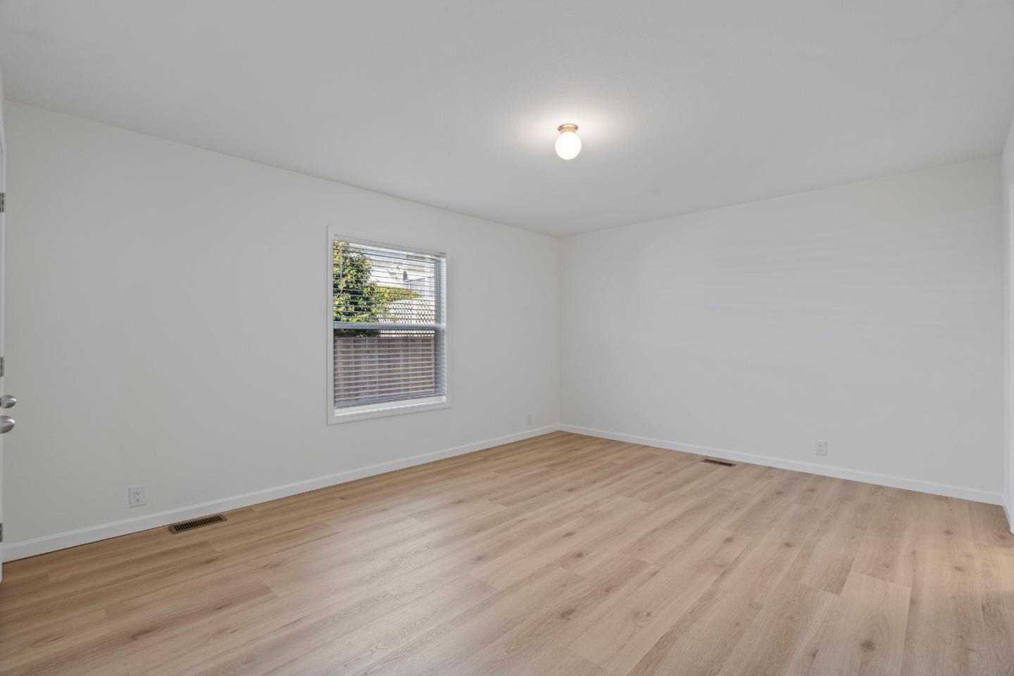 144 Holm Road, Unit 120 Watsonville, CA 95076 - Photo 21 of 25 a view of room with window and hardwood floor