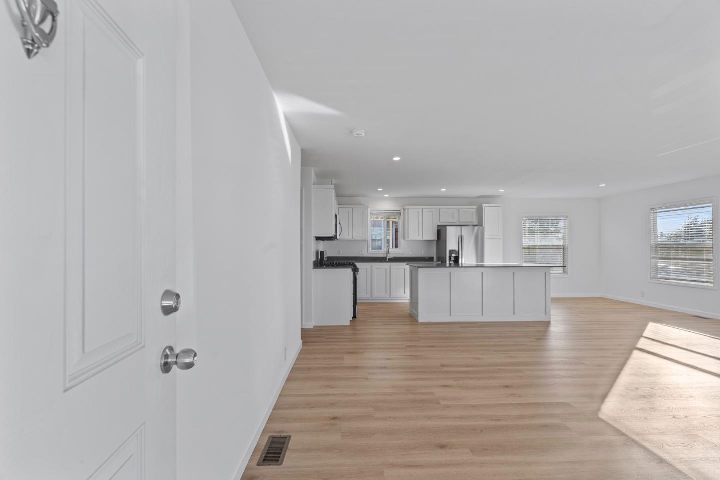 144 Holm Road, Unit 120 Watsonville, CA 95076 - Photo 7 of 25 a view of kitchen with furniture and wooden floor
