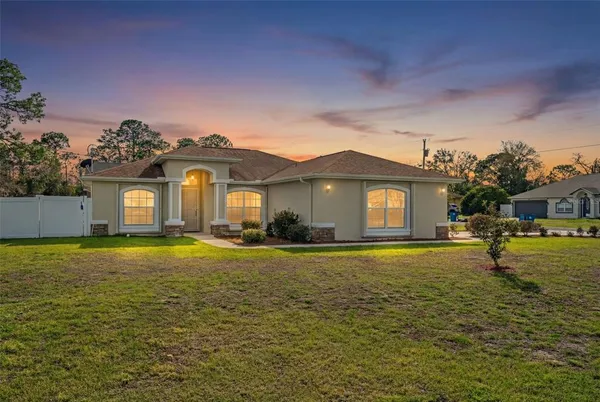 a front view of a house with a yard