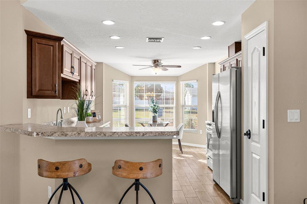 5346 Pierpoint Avenue Spring Hill, FL 34608 - Photo 11 of 41 a kitchen with stainless steel appliances granite countertop a refrigerator and a sink
