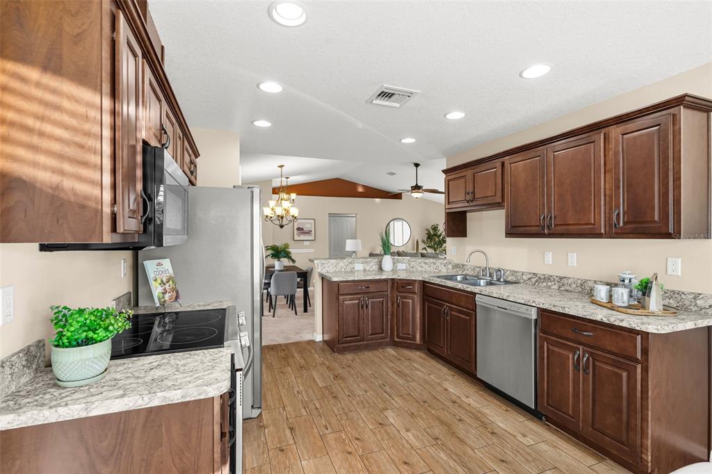 5346 Pierpoint Avenue Spring Hill, FL 34608 - Photo 14 of 41 a kitchen with lots of counter top space and wooden floor