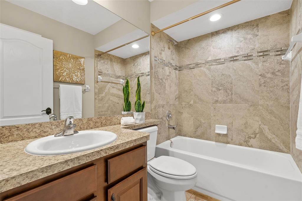 5346 Pierpoint Avenue Spring Hill, FL 34608 - Photo 17 of 41 a bathroom with a granite countertop sink toilet and shower