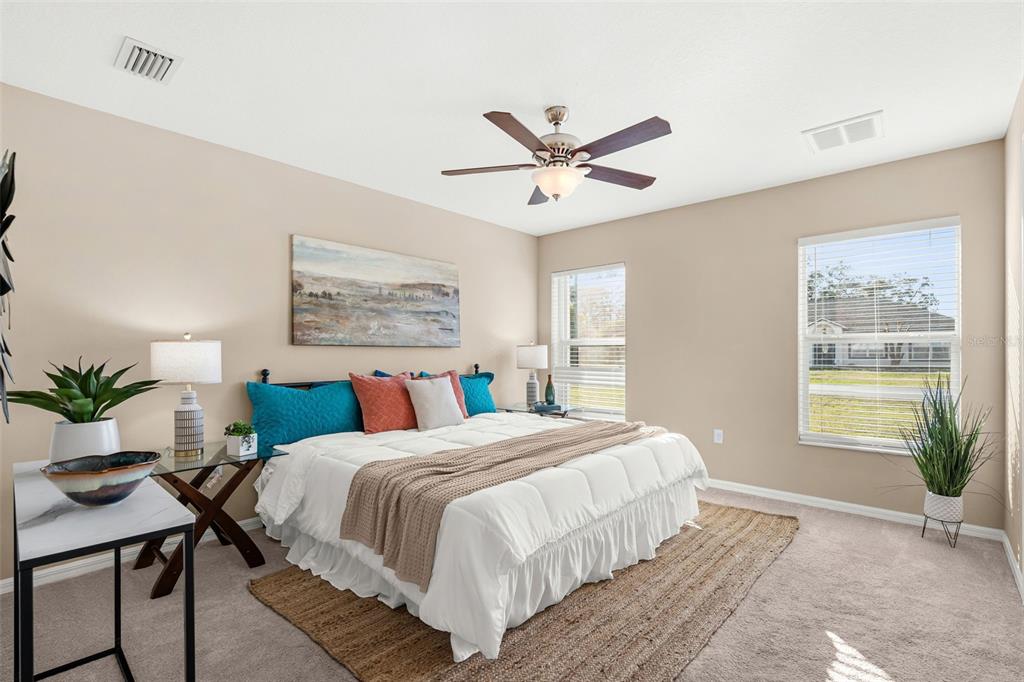 5346 Pierpoint Avenue Spring Hill, FL 34608 - Photo 18 of 41 a bedroom with a large bed and a chandelier