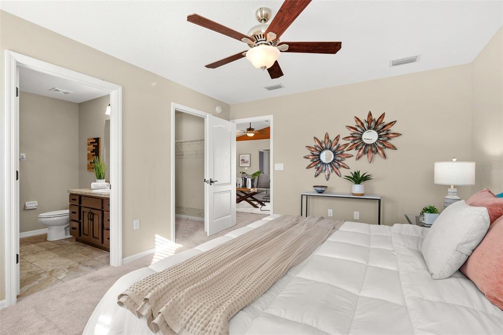 5346 Pierpoint Avenue Spring Hill, FL 34608 - Photo 19 of 41 a bedroom with a large bed and a chandelier