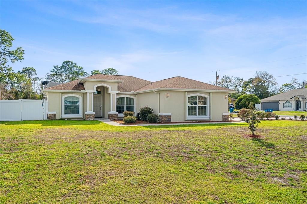 5346 Pierpoint Avenue Spring Hill, FL 34608 - Photo 2 of 41 a front view of a house with a yard