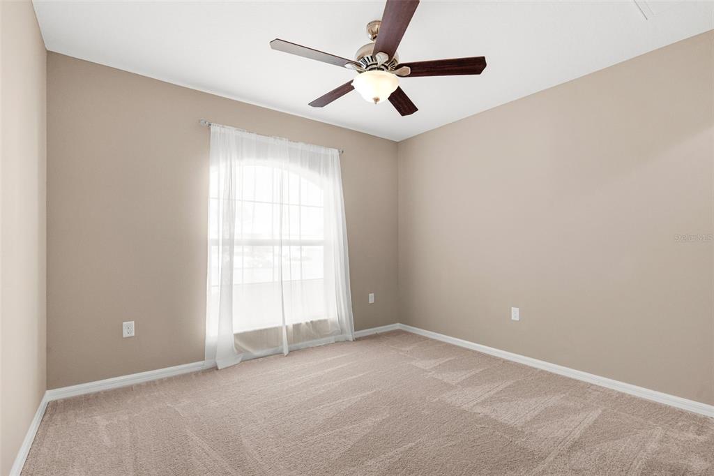 5346 Pierpoint Avenue Spring Hill, FL 34608 - Photo 23 of 41 an empty room with windows and fan