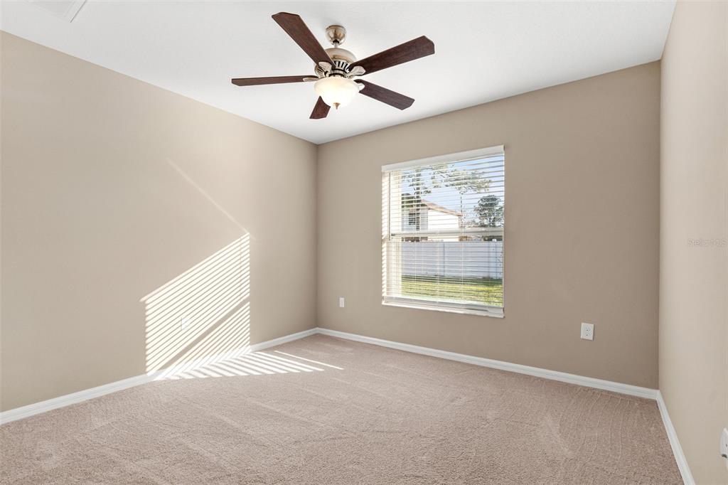 5346 Pierpoint Avenue Spring Hill, FL 34608 - Photo 25 of 41 an empty room with ceiling fan and windows