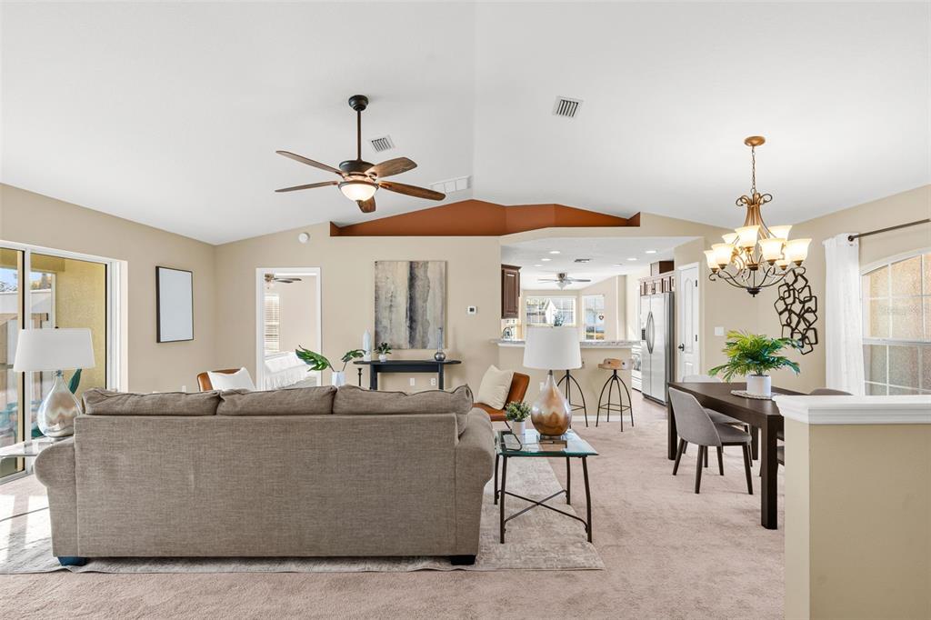 5346 Pierpoint Avenue Spring Hill, FL 34608 - Photo 5 of 41 a living room with furniture and a chandelier