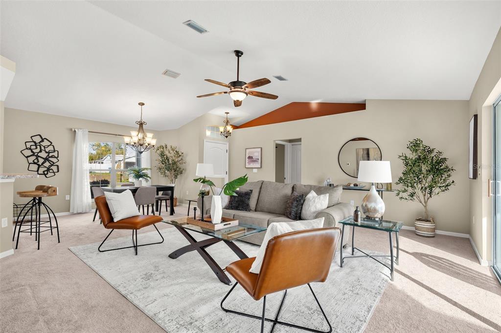 5346 Pierpoint Avenue Spring Hill, FL 34608 - Photo 6 of 41 a living room with furniture a chandelier and a window