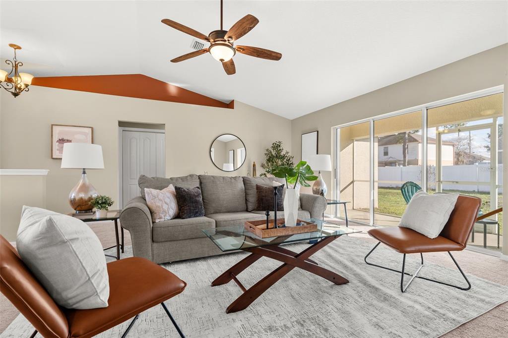 5346 Pierpoint Avenue Spring Hill, FL 34608 - Photo 8 of 41 a living room with furniture a chandelier and a window